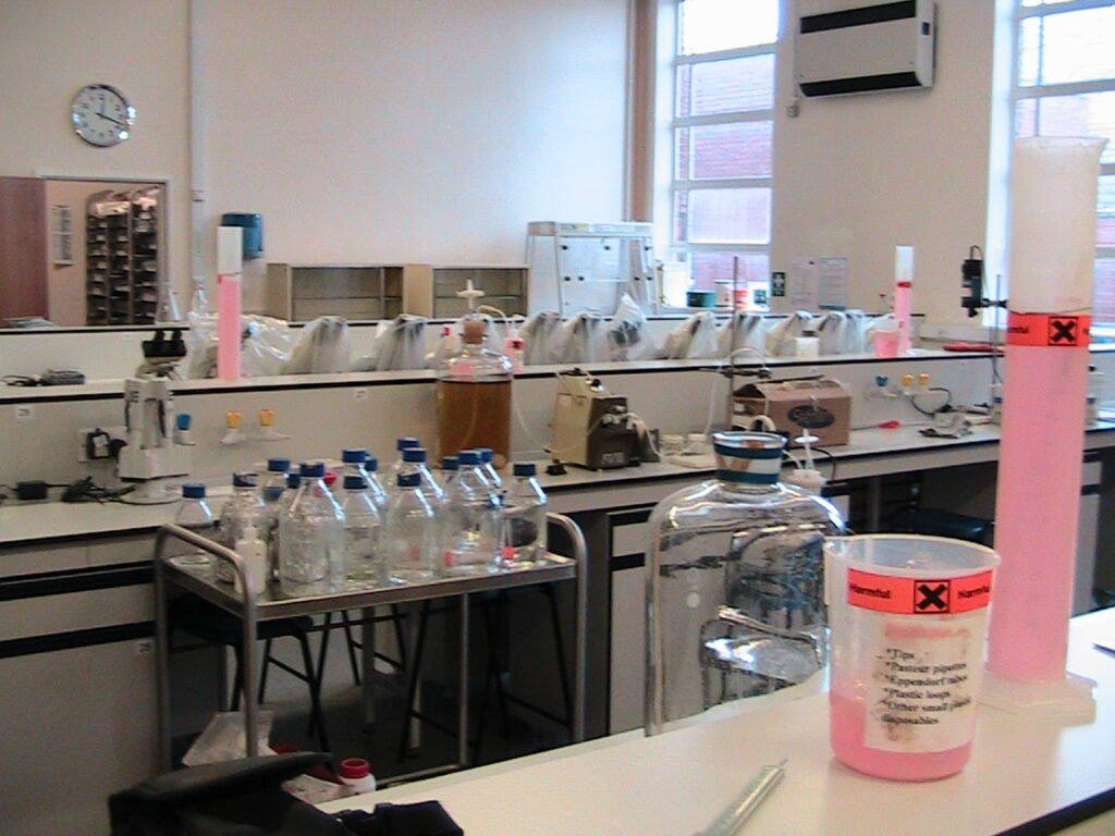 Archival view of a microbiology laboratory with glassware and equipment, photographed in 2011; not the new UK AI Biosecurity Lab.