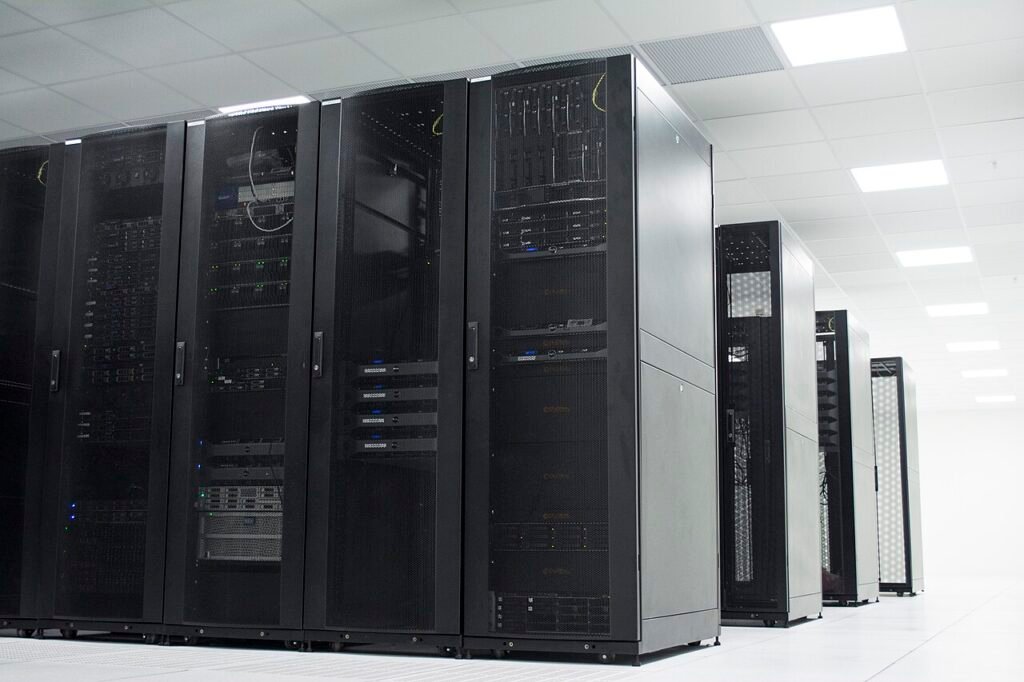 Archival photograph of black server racks in a brightly lit GIP Networks data center; not a Moonshot AI facility