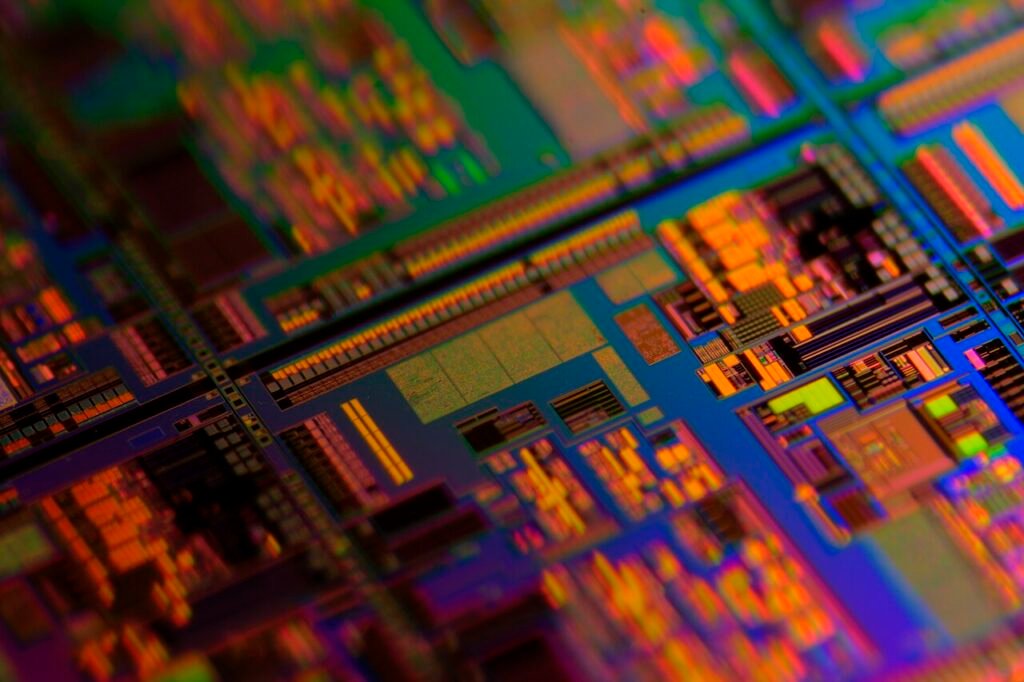 Close-up archival photograph of a multicolored silicon wafer, illustrating semiconductor manufacturing; not a SK hynix facility or October 2026 event