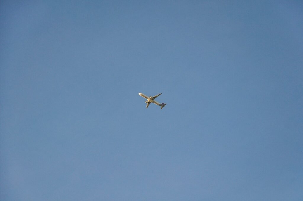 Illustrative commercial aircraft flying across a clear blue sky; not a Norwegian Air Shuttle aircraft or an image of a specific 2026 flight.