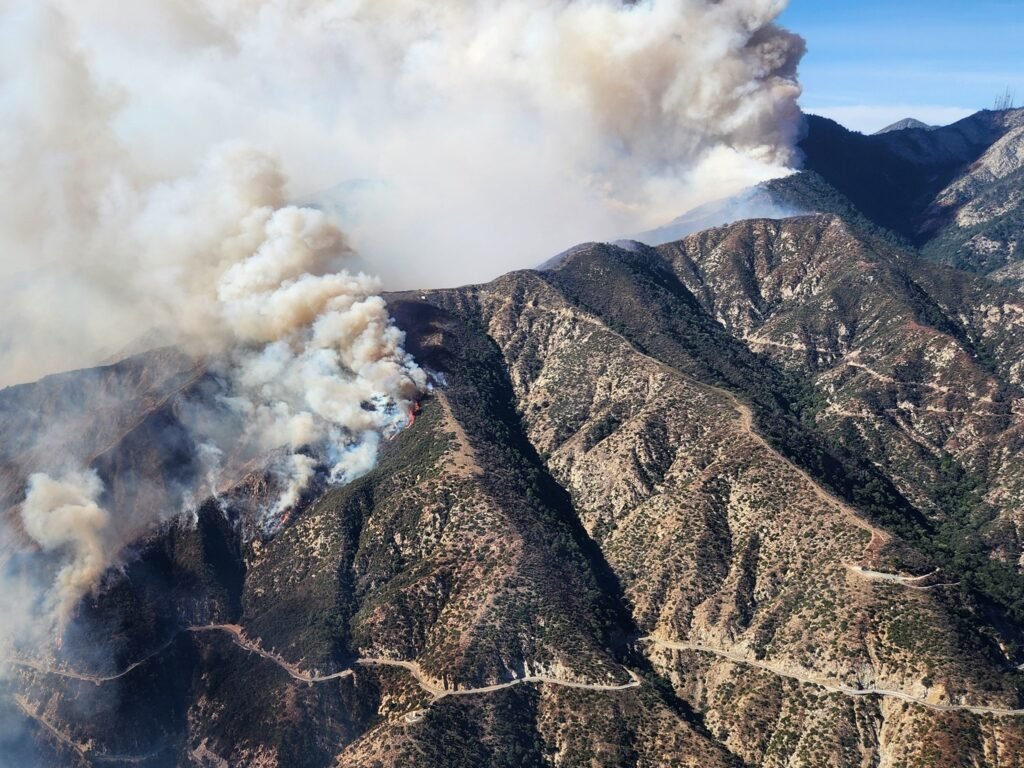 Smoke from the Eaton Fire rises over the San Gabriel Mountains near Los Angeles on January 8, 2025; USDA Forest Service aerial photograph.