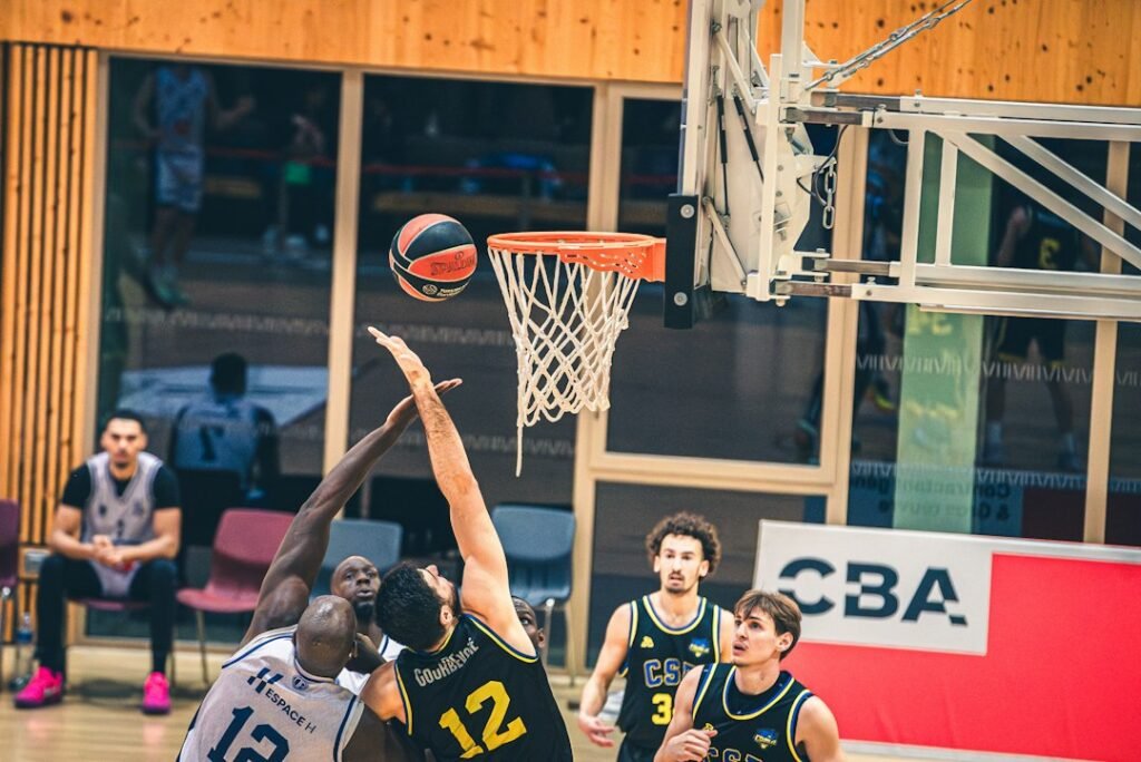 Illustrative photograph of basketball players reaching for the ball near a hoop; not from the October 28, 2026 Nuggets–Pelicans game
