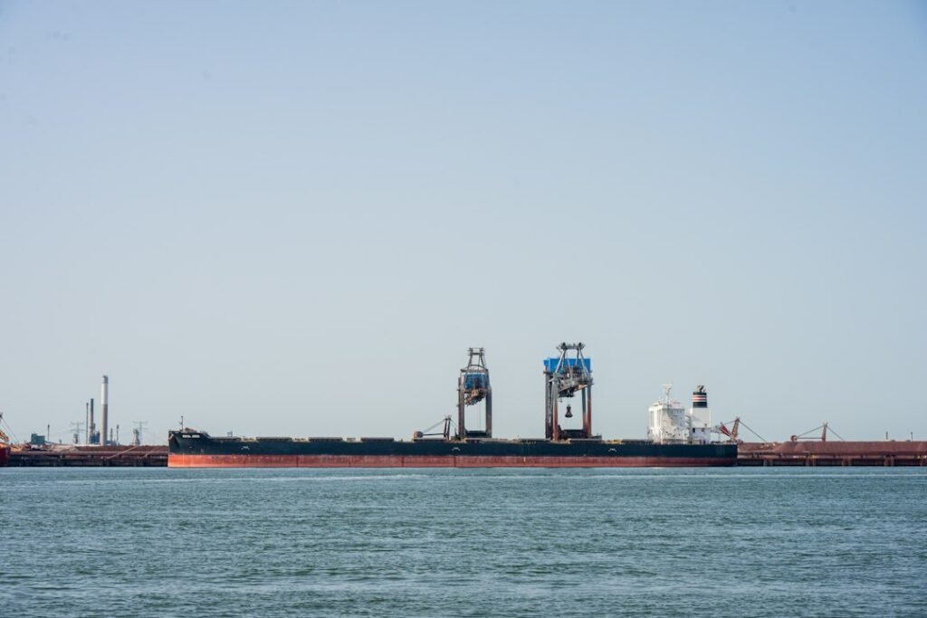 Illustrative photograph of a bulk cargo ship with harbor cranes; not footage of the October 2026 Black Sea diplomacy