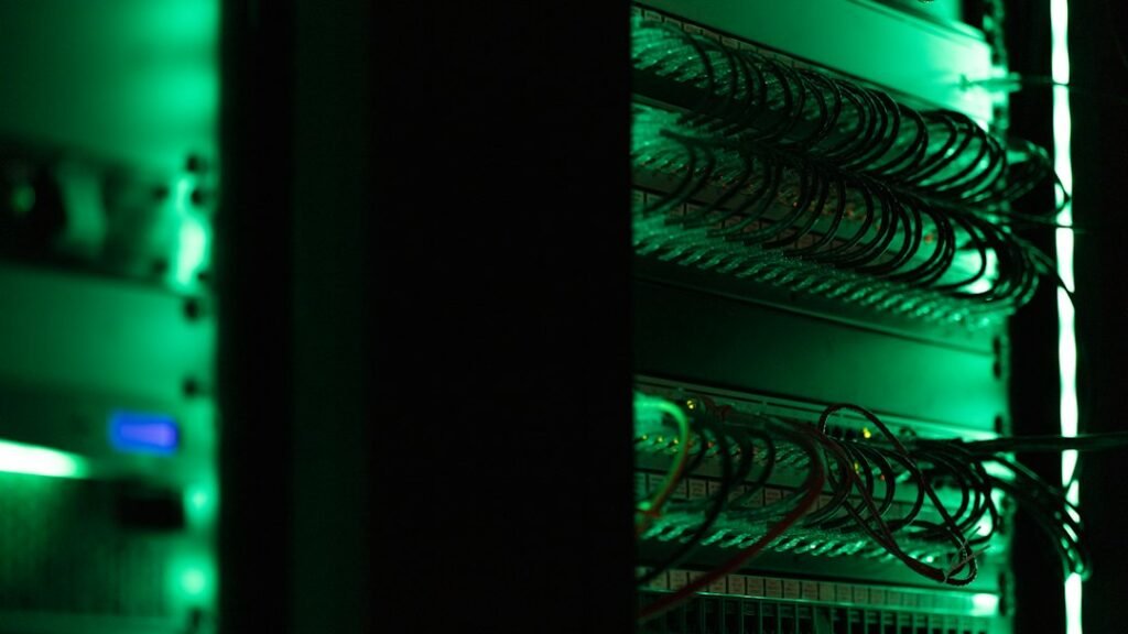 Illustrative photograph of server racks in a dark data center; not a specific Oracle facility.
