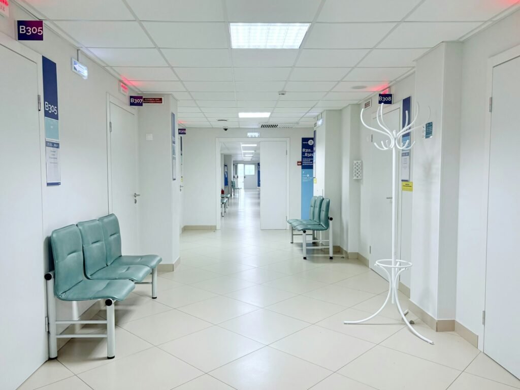 Illustrative photograph of an empty hospital corridor with benches and doors; not a photograph of Yemen or the current conflict.