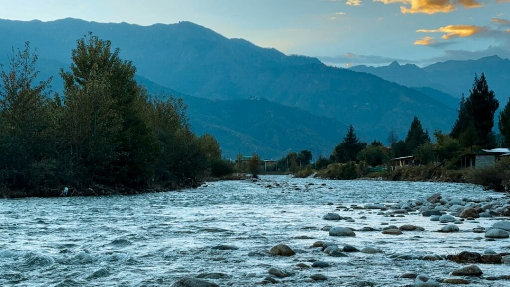 Illustrative photograph of a river winding through the hills near Paro, Bhutan; not footage of the October 2026 Shintaphu flood.