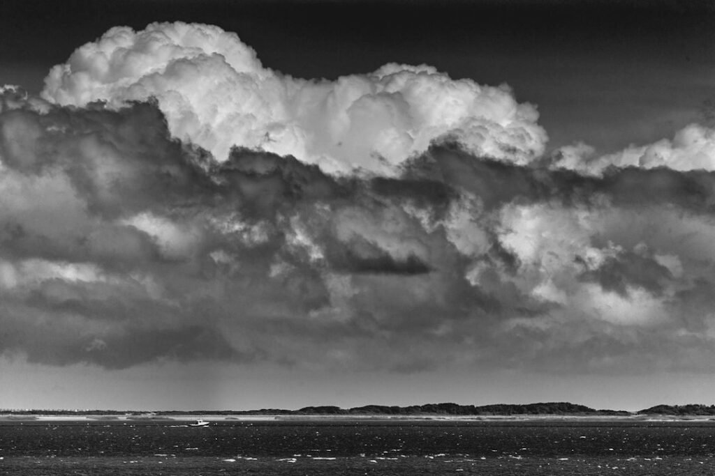 Dark storm clouds over a body of water; illustrative stock photo, not Cyclone Arnab or the Indian coast.