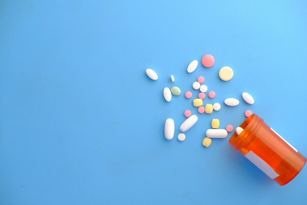 Illustrative unbranded medication capsules and bottle, not Eli Lilly products