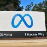 Blue Meta infinity logo on the company’s headquarters entrance sign at 1 Hacker Way in Menlo Park, California, photographed in May 2022.