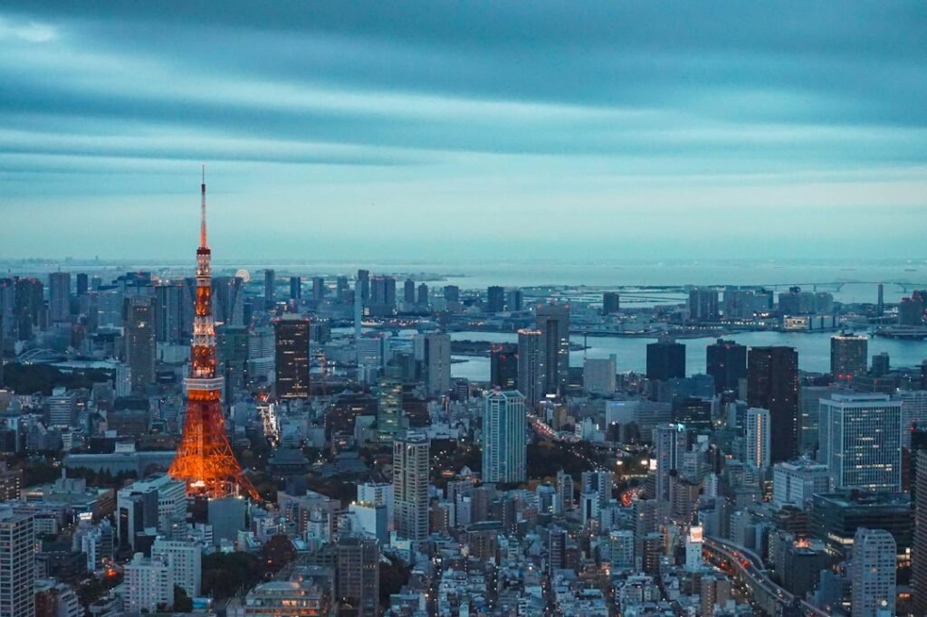 Archival photograph of Tokyo Tower glowing orange above the Tokyo skyline at dusk; illustrative image, not a photograph of the October 2026 cyber incidents